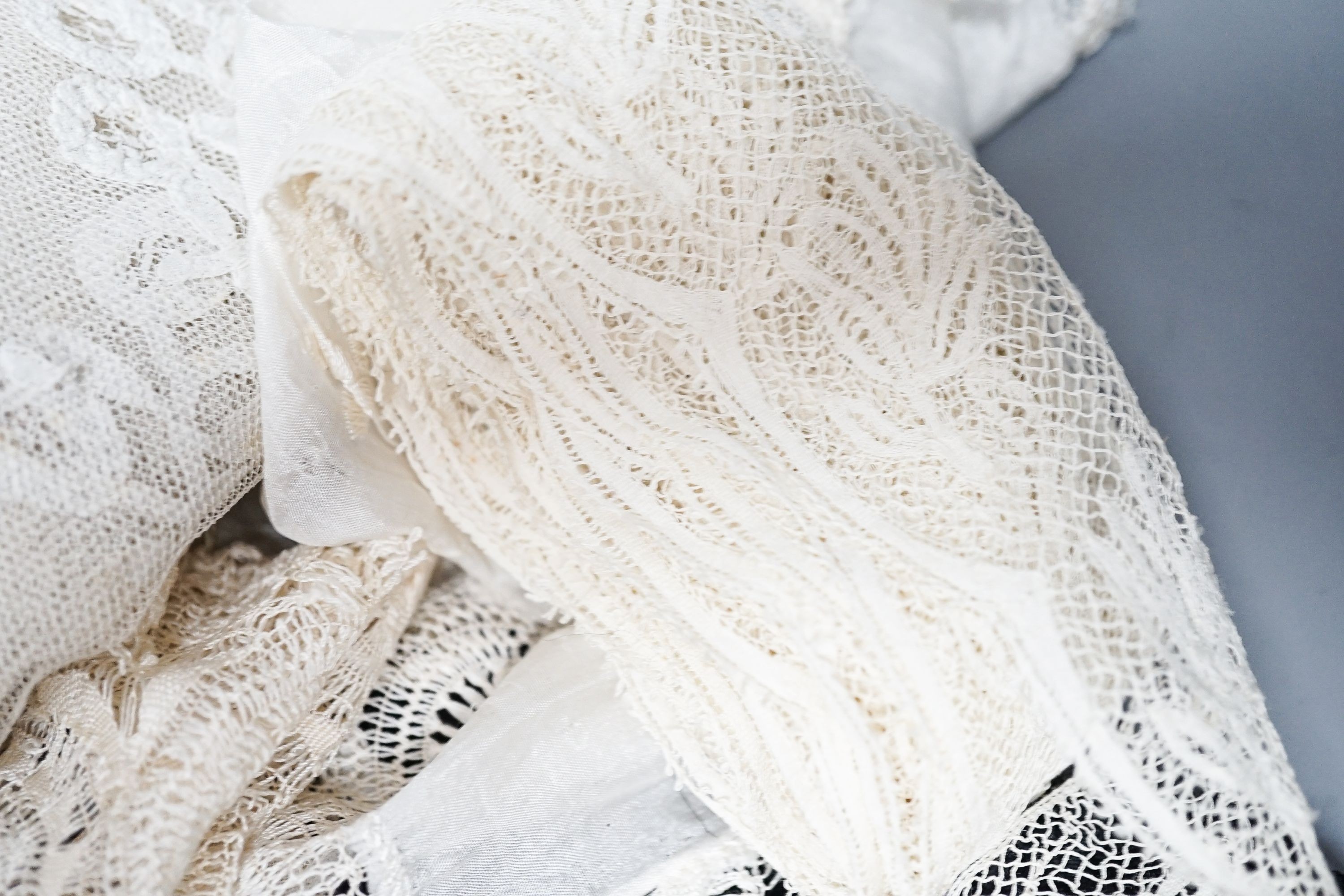A large tape lace 'Bertha', various hand made laces, lengths of needle run laces, a skirt panel etc.